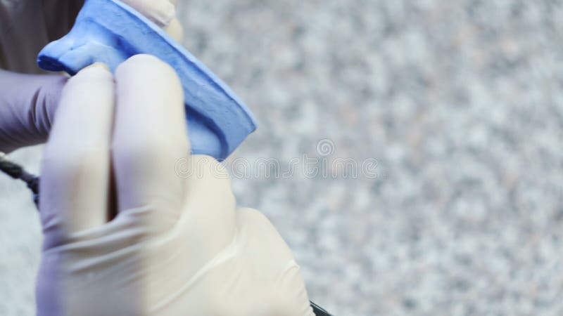 Closeup of a dental technician making of denture in a dental lab stock footage