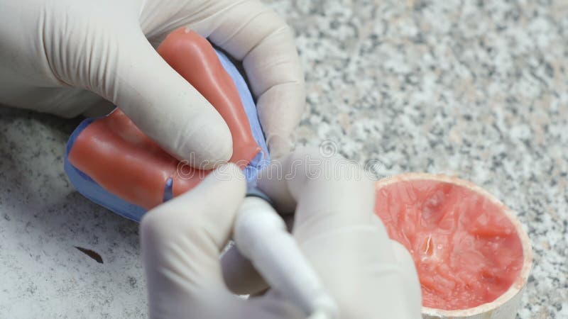 Closeup of a dental technician making of denture in a dental lab stock footage