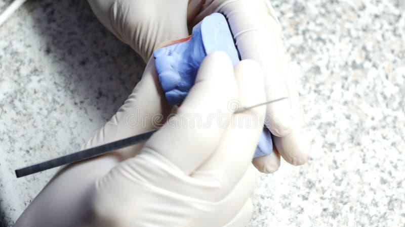 Closeup of a dental technician making of denture in a dental lab stock footage