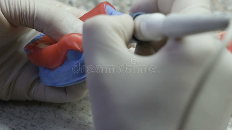 Closeup of a dental technician making of denture in a dental lab stock footage