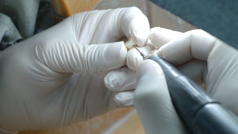 Closeup of a dental technician making of denture in a dental lab stock footage