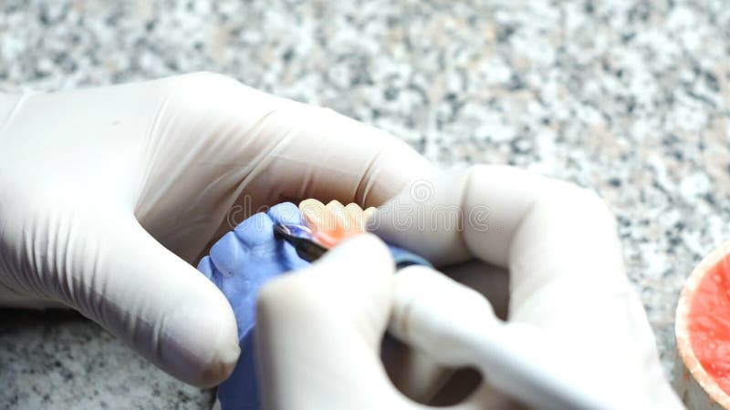 Closeup of a dental technician making of denture in a dental lab stock video