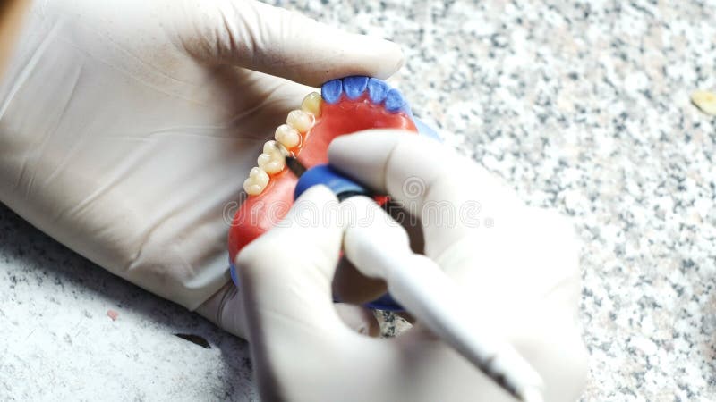 Closeup of a dental technician making of denture in a dental lab stock video footage