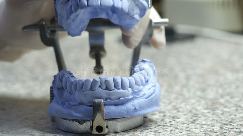 Closeup of a dental technician making of denture in a dental lab. stock footage