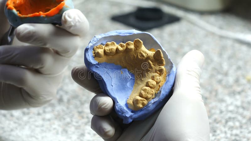 Closeup of a dental technician making of denture in a dental lab. stock video footage