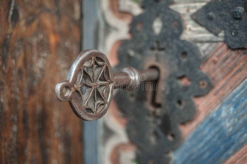 Closeup of old massive metal key in church ancient door