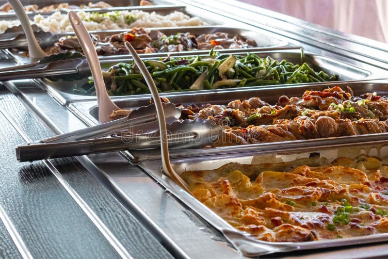 Closeup of different dishes on the display at a buffet with a blurry background stock photography