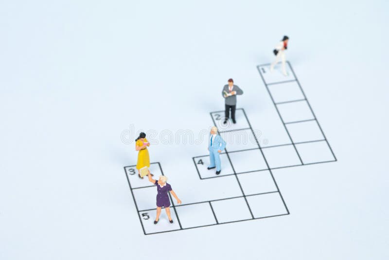 Closeup of Different Figurines Standing on a Crossword Puzzle Stock Image Image of game