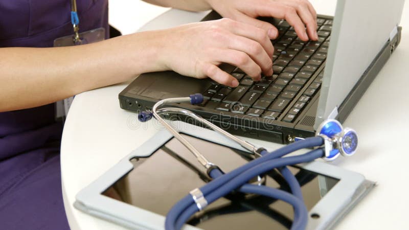 Closeup of doctor typing on a laptop stock video footage