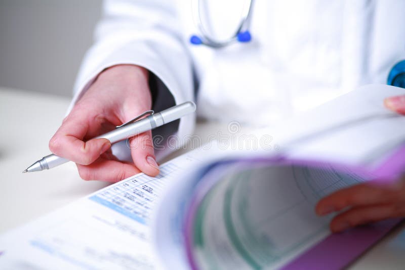Closeup of a female doctor looking a medical file stock photography Closeup of a female doctor looking a medical file stock photography