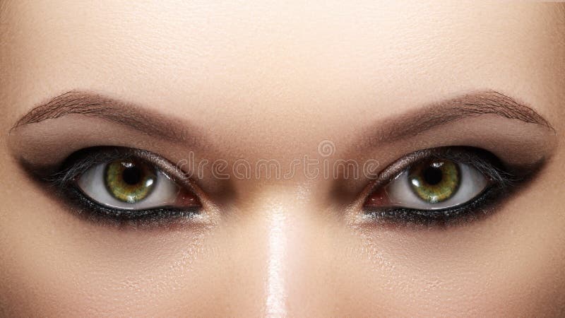 Closeup female eyes with bright make-up, great shapes brows, extreme long eyelashes. Celebrate makeup, luxury eyeshadows