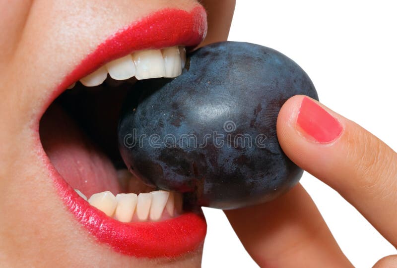 Closeup of female mouth biting a plum