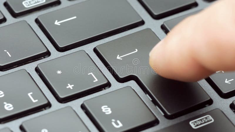 Closeup finger pressing enter key on modern laptop keyboard footage 4k stock footage