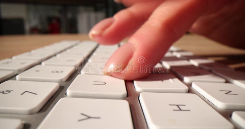 Closeup of fingers typing on white keyboard stock video footage