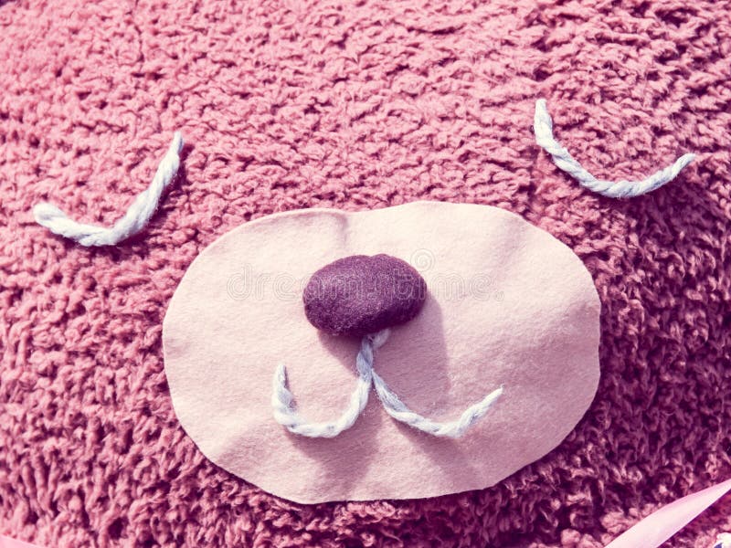 Closeup of a fluffy pink teddy bear with an adorable face royalty free stock photography