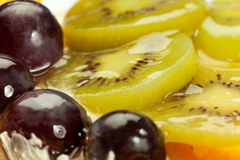 Closeup of a fruit cake with grapes and kiwi topping