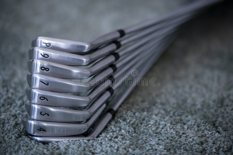 Closeup of Golf Clubs with Size Numbers on Them Under the Lights with a