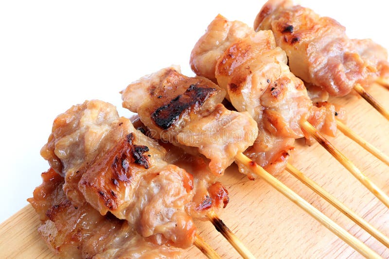 Premium Photo  Closeup of grilled skewered milk pork on stick thai street  food market