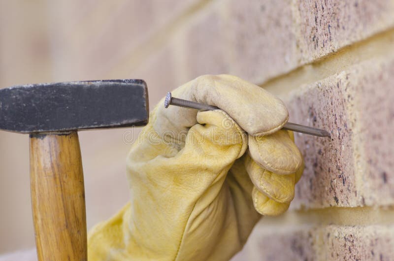 Closeup Hand With Nail And Hammer At Wall Stock Image Image of