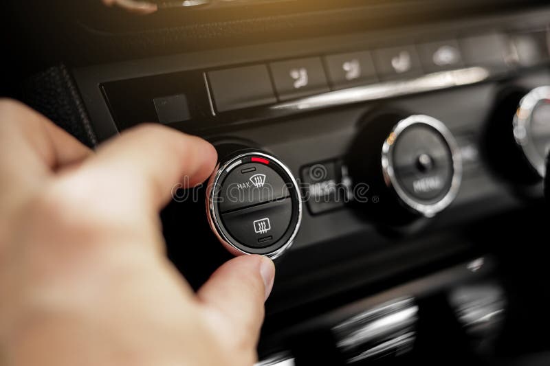 Closeup of Hand Adjusting the Conditioner in a Modern Car. Dashboard