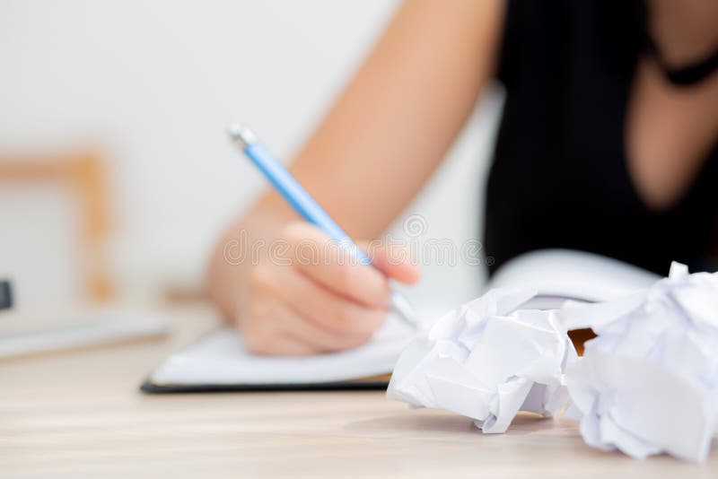 Closeup hand asian woman writer thinking idea and writing on notebook or diary with happy on desk office stock images Closeup hand asian woman writer thinking idea and writing on notebook or diary with happy on desk office stock images