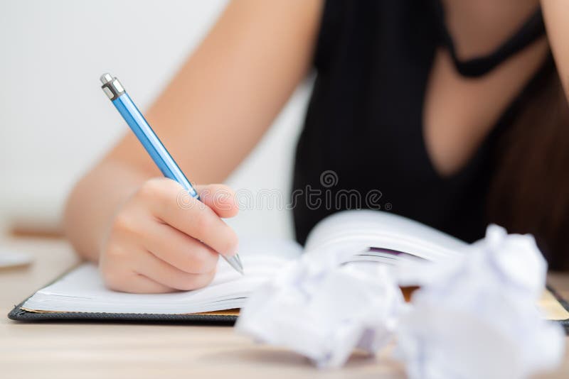 Closeup hand asian woman writer thinking idea and writing on notebook or diary with happy on desk office royalty free stock photo Closeup hand asian woman writer thinking idea and writing on notebook or diary with happy on desk office royalty free stock photo
