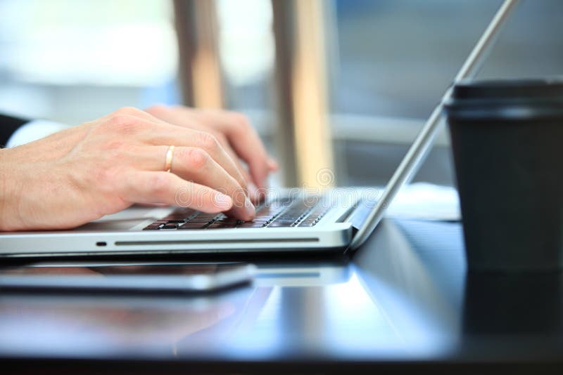 Closeup of hand business man using laptop for work at office stock photography Closeup of hand business man using laptop for work at office stock photography