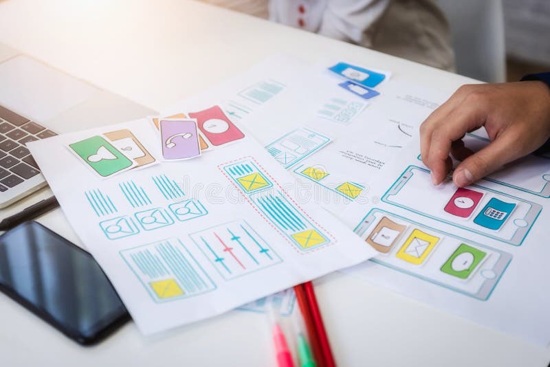 Closeup hand of graphic designer working about wireframe application design on the desk in office. User experience concept. Program coding working stock images, royalty-free photos and pictures