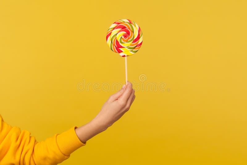 Closeup of Hand Holding Appetizing Round Rainbow Candy on Stick, Big ...