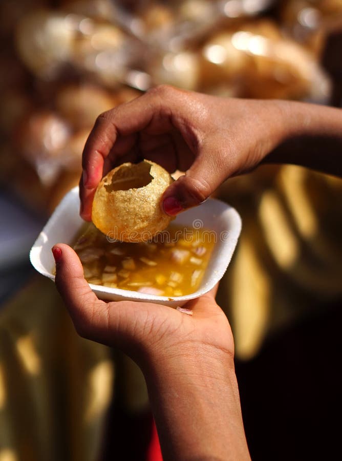 Hand holding  Indian street food  masala chaat pani puri