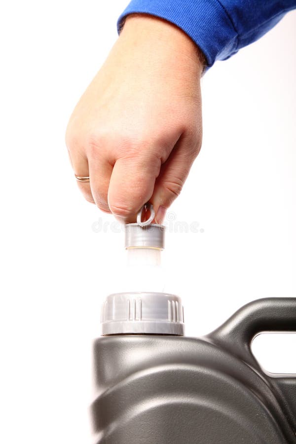 Hand opening can with car engine oil isolated royalty free stock photo Hand opening can with car engine oil isolated royalty free stock photo