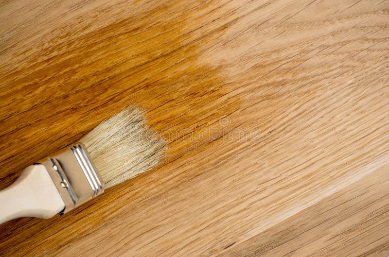 Closeup Hand Use Brush Paint Clear Lacquer on Wood Surface Stock Image