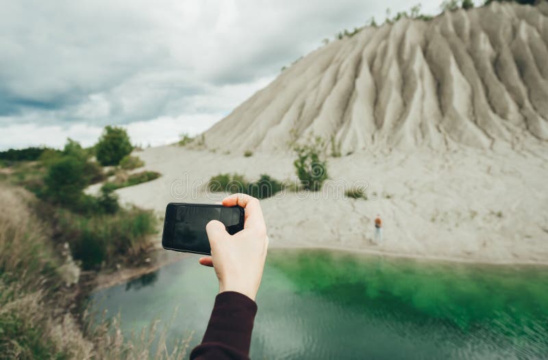 Closeup hand of woman taking photo pictures on his mobile cell phone during his adventure on the nature stock photo Closeup hand of woman taking photo pictures on his mobile cell phone during his adventure on the nature stock photo