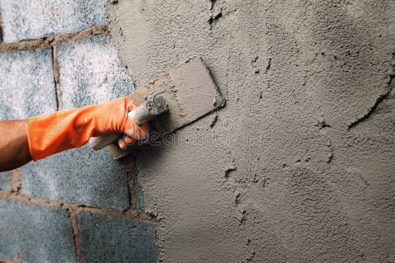 Hand Of Worker Use Trowel Plastering A Newly Poured Concrete On