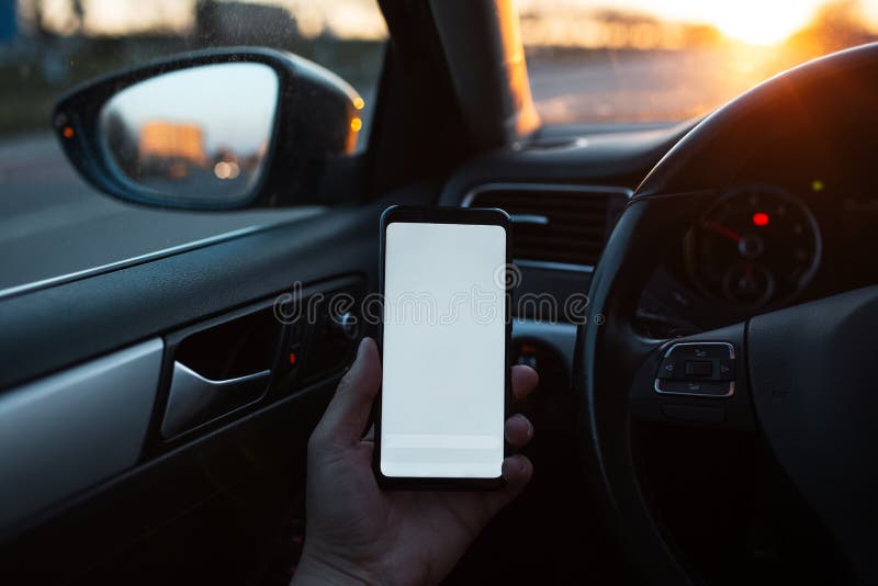 Closeup of handing smartphone with mockup in the car stock photo Closeup of handing smartphone with mockup in the car stock photo
