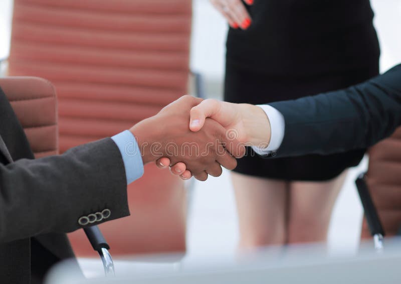 Closeup.handshake of business partners on the background of the office stock image Closeup.handshake of business partners on the background of the office stock image