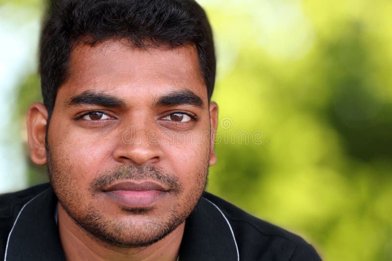 Photo of handsome middle-aged Indian/asian youth with content and satisfied look. The eyebrows are thick and prominent and hair is black and curly with unshaven stubble on the face. Photo of handsome middle-aged Indian/asian youth with content and satisfied look. The eyebrows are thick and prominent and hair is black and curly with unshaven stubble on the face.