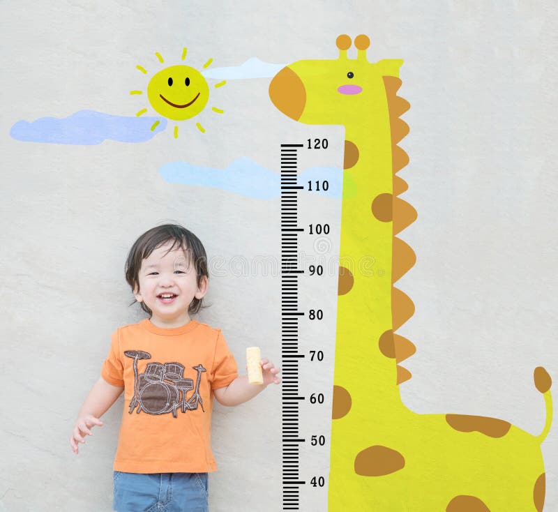 Closeup happy asian kid stand for measure height with cute cartoon at the marble stone wall textured background