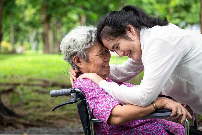 Closeup,Happy beautiful asian senior people with adult woman hugging,smiling in summer,love of mother with her daughter in