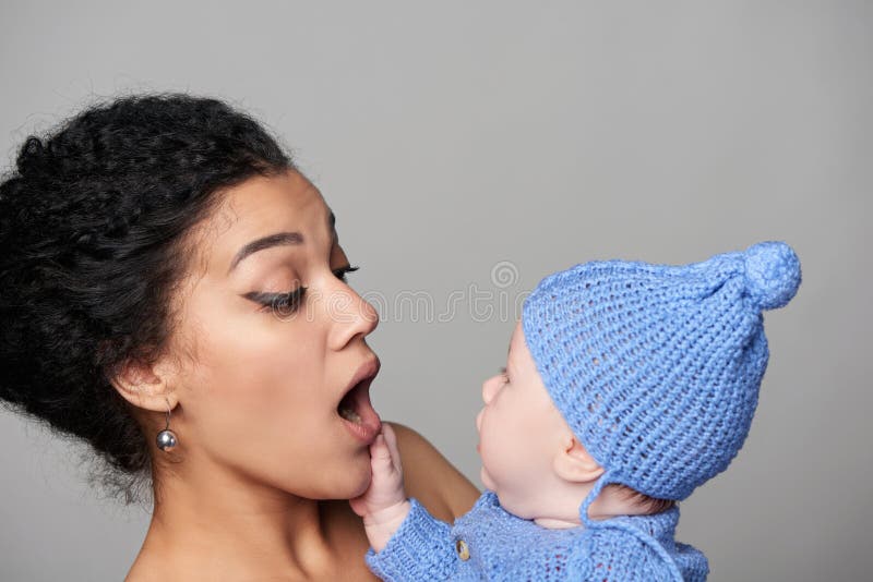 Pretty woman holding a baby in her arms royalty free stock photos Pretty woman holding a baby in her arms royalty free stock photos
