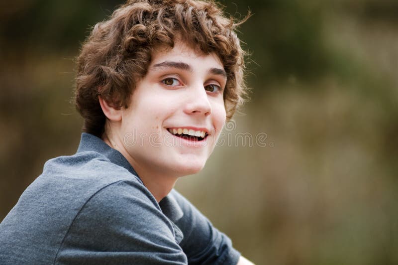 Closeup of a Caucasian teen boy outdoors looking at camera. Closeup of a Caucasian teen boy outdoors looking at camera