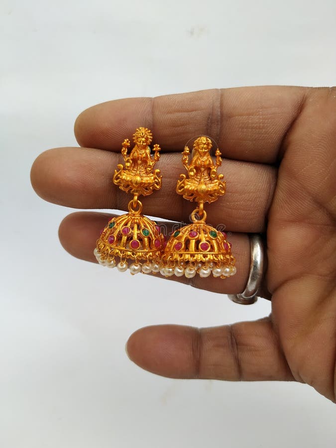 Holding Goddess Lakshmi Statues in the Golden Traditional Hand Crafted Ear  Ring with Stones and Gems Isolated on White Background Stock Photo - Image  of accessory, earrings: 187504966
