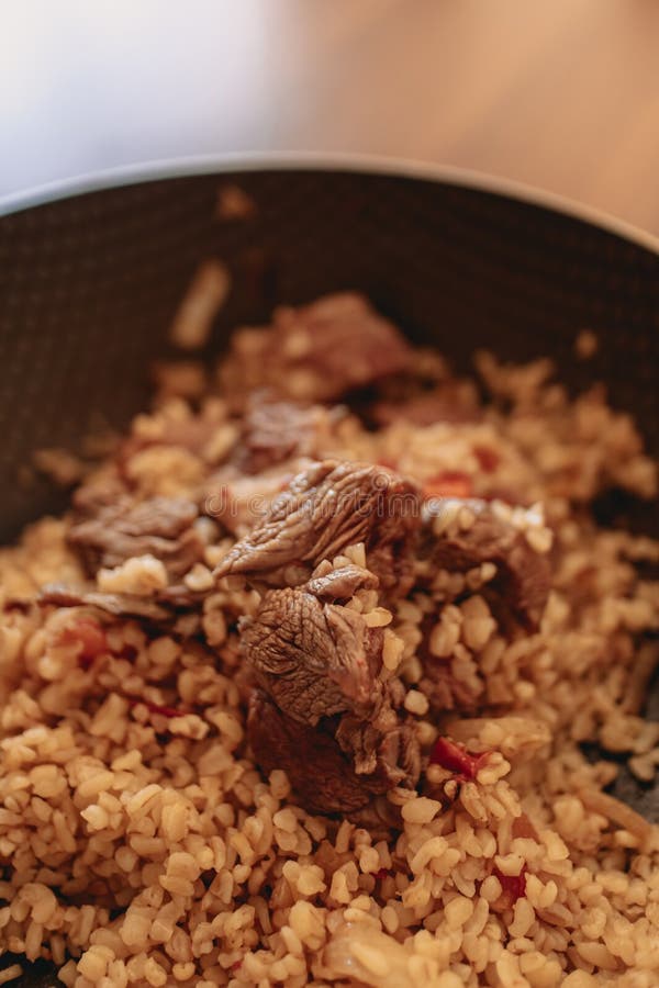 Closeup of Beef Fried Rice Served in Black Iron Pan. Stock Photo