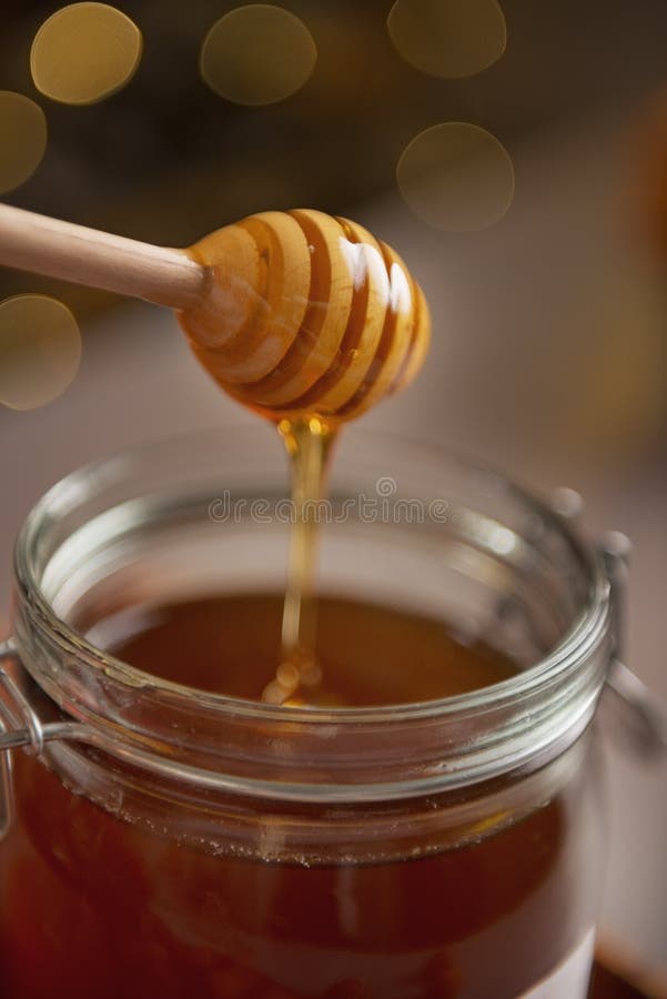 Closeup on Honey Flowing Down from Honey Dipper in Jar Stock Image Image of natural, lights