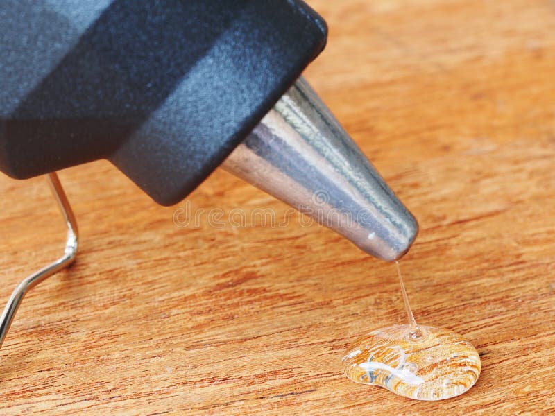 closeup hot glue gun with melted glue dripping out royalty free stock photo closeup hot glue gun with melted glue dripping out royalty free stock photo