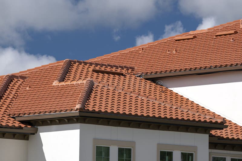 Closeup of House Rooftop Covered with Ceramic Shingles. Tiled Covering