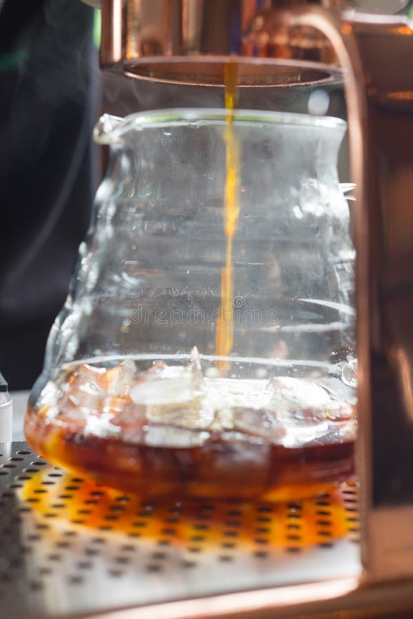 Closeup Image of a Drip Coffee Dropping into a Beaker Stock Photo