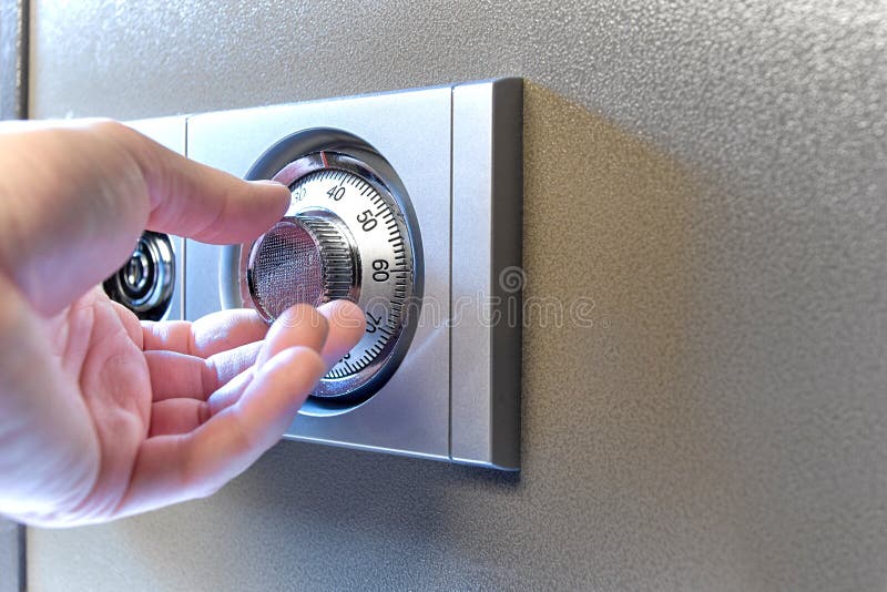 Closeup image of a hand opens a mechanical lock of a safe. royalty free stock photos Closeup image of a hand opens a mechanical lock of a safe. royalty free stock photos