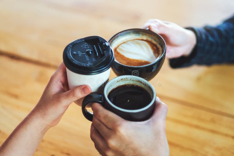 People Enjoyed Drinking and Clinking Coffee Cups on the Table in Cafe