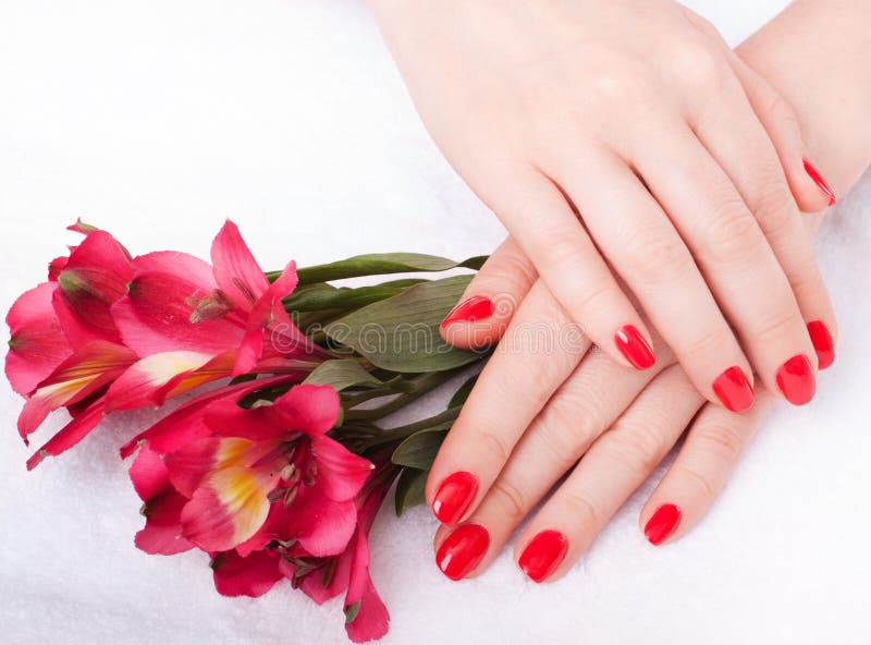 Closeup image of red manicure with flowers